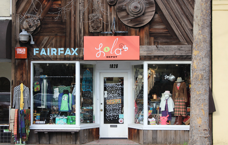 outdoor store front, reclaimed wood siding, signs say Lola's Depot, Fairfax, windows display vintage clothing and items