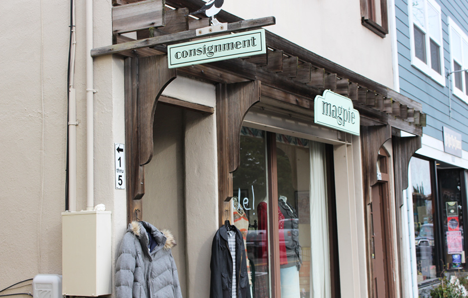 outdoor store front, signs say consignment, Magpie, windows says sale, clothing displayed