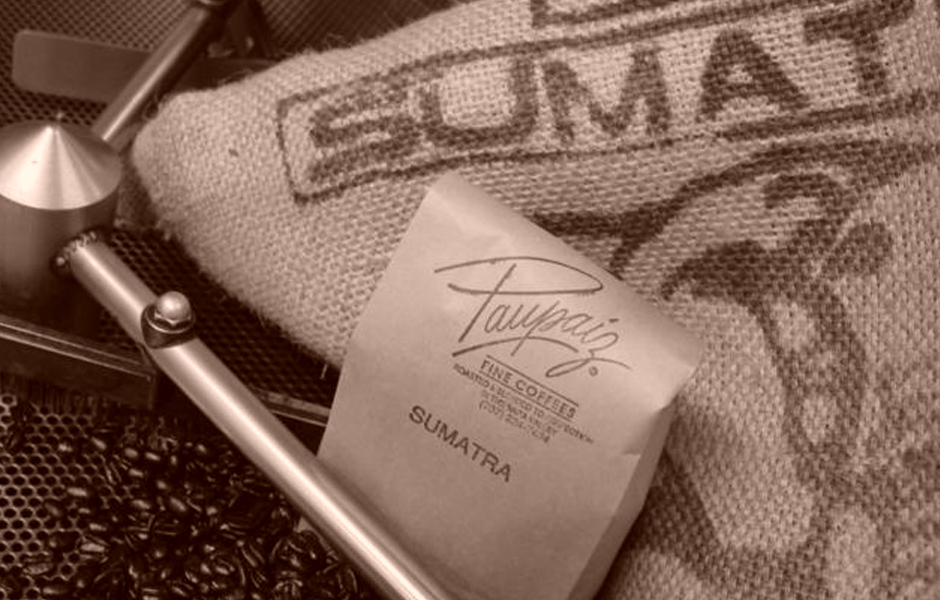 top of commercial grade coffee bean mixer, coffee beans, sack says sumatra, paper bag says Paupaiz Fine Coffee Sumatra