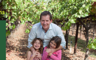 Honig Winery owner smiling in vineyard with his two daughters