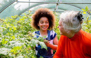 Family members in greenhouse together, celebrate earth day every day