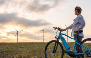 looking ahead, energy future, wind turbines, woman with ebike